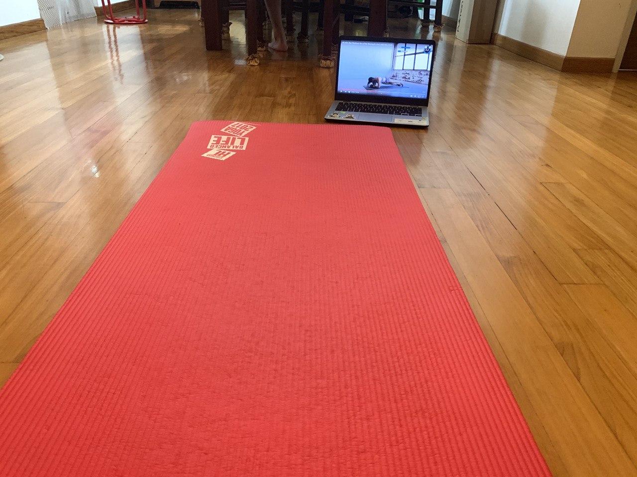 A fitness mat with a laptop showing Chloe Ting's ab workout for people who are trying to stay fit during the circuit breaker period which was set in order to contain the spread of Covid-19 cases in Singapore.