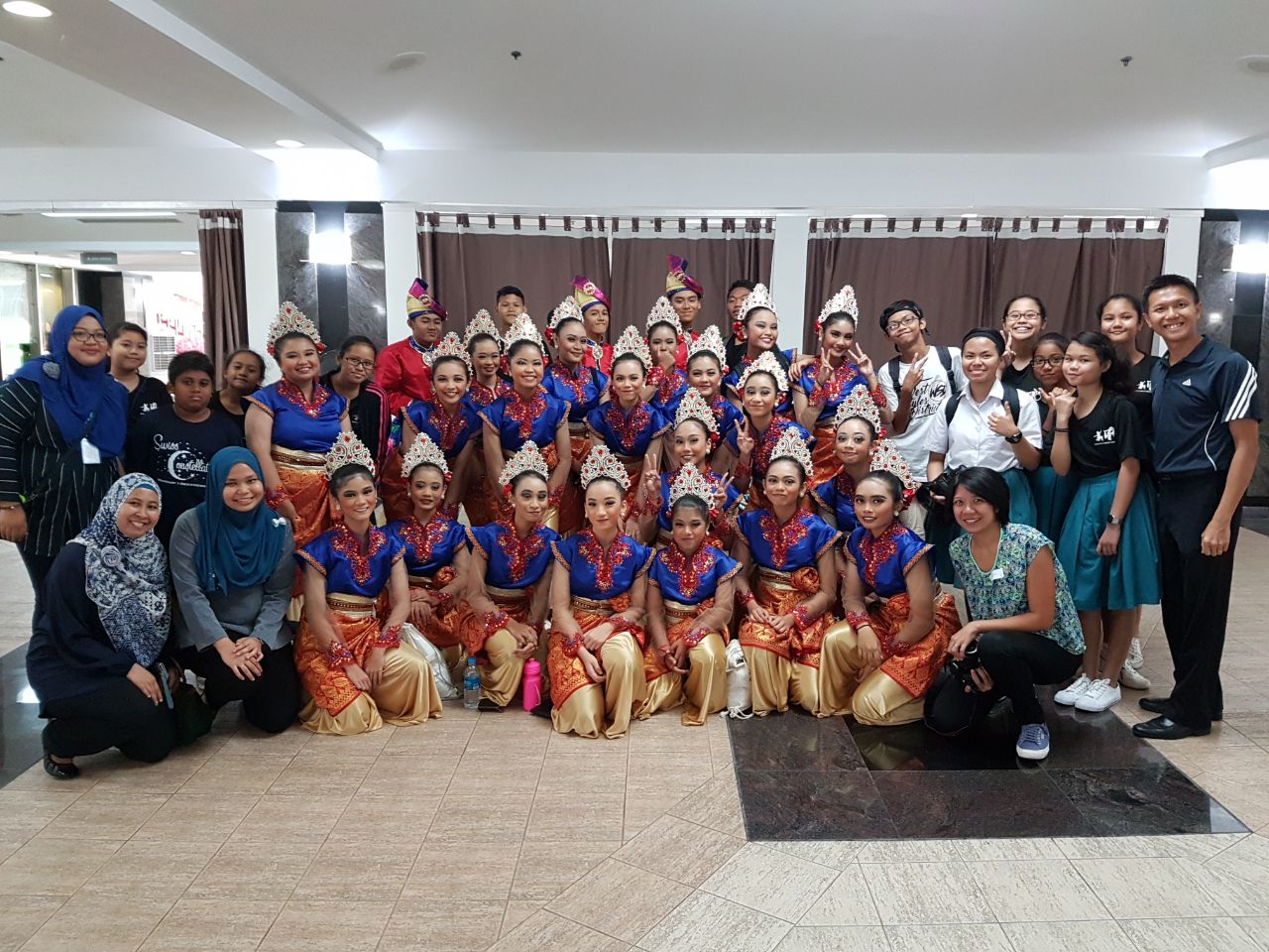 leow su qi with her malay dance group posing for a photo